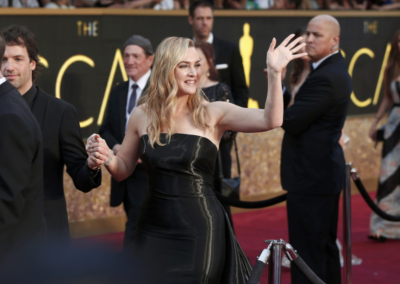 Kate Winslet, nominated for Best Supporting Actress for her role in "Steve Jobs", wearing a strapless, shiny black Ralph Lauren gown, poses as she arrives at the 88th Academy Awards in Hollywood, California